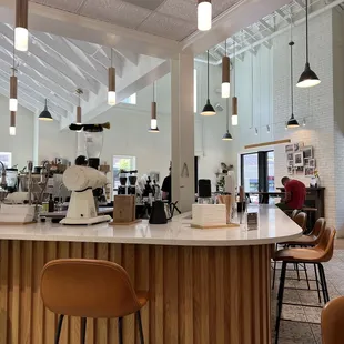 a coffee shop with a counter and chairs