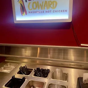 Utensils next to drinks in the back