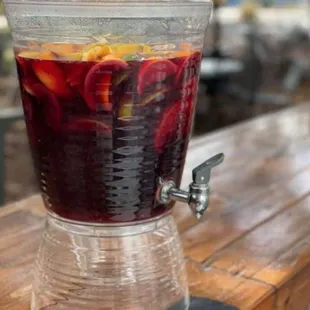 a drink dispenser filled with fruit