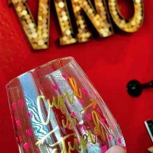 a hand holding a wine glass