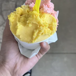 a hand holding a cone of ice cream