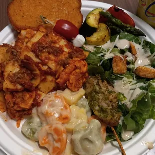 Lasagna, Tortellini, pesto chicken/tomato mozzarella skewer, Caesar salad, bread, grilled veggies. Dessert.