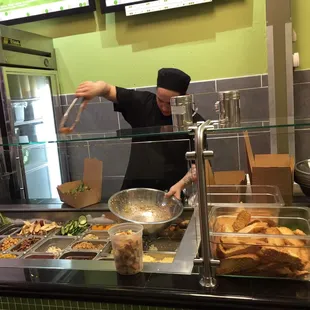 a man preparing food in a restaurant kitchen