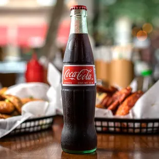 a bottle of coca cola sitting on a table