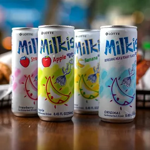 three cans of milkshake on a table