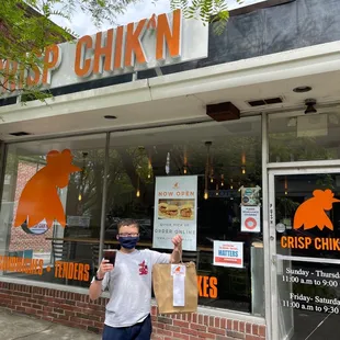 a man standing outside of a restaurant