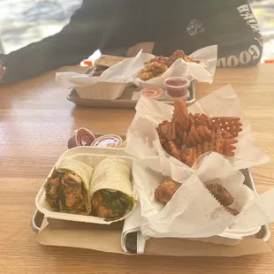 A Nashville Hot wrap with Sweet Potato Waffle Fries and 5 Piece Bites.
