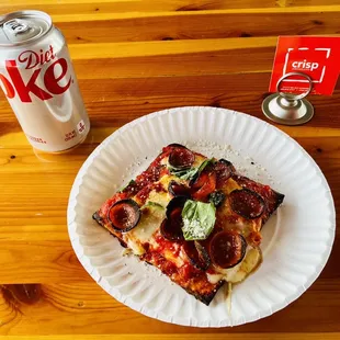 a slice of pizza on a paper plate