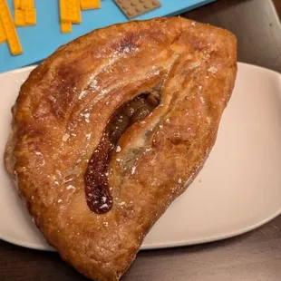 Turnover bursting with chunky, sweet apple filling.