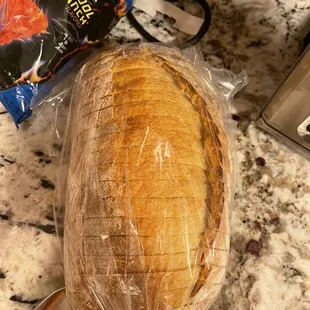 a loaf of bread wrapped in plastic