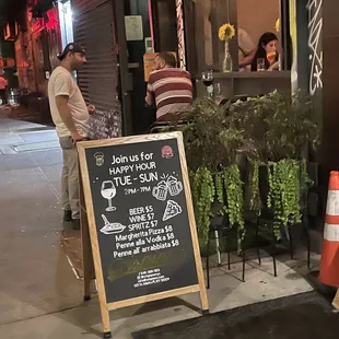 a chalkboard sign on the sidewalk