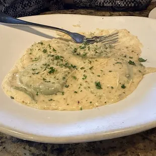 Ravioli with white sauce.