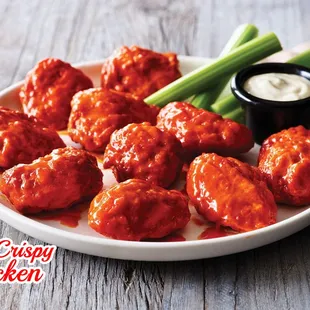 a plate of buffalo wings and celery