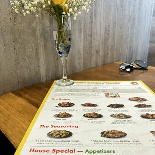  a menu with a vase of flowers