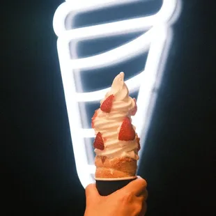 a hand holding an ice cream cone
