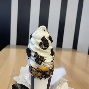 a cupcake with whipped cream and chocolate chips