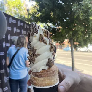 a person holding a cup of ice cream