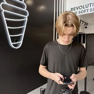 a young man looking at his cell phone