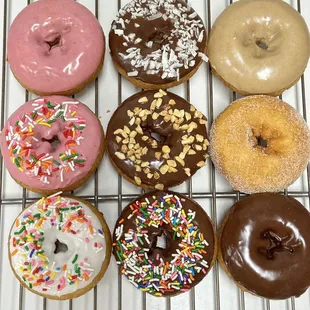a variety of donuts on a cooling rack