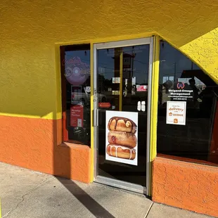 a sign in front of a donut shop
