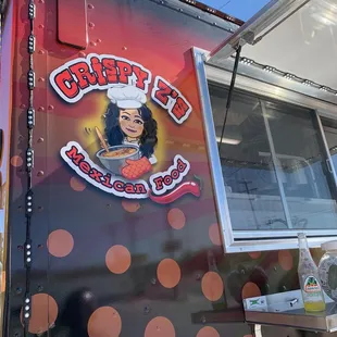 a woman in a chef's hat on the side of a food truck