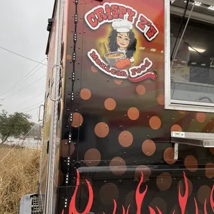 a food truck with flames on the side