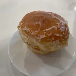 a glazed donut on a white plate