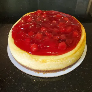 a cheesecake topped with cherries