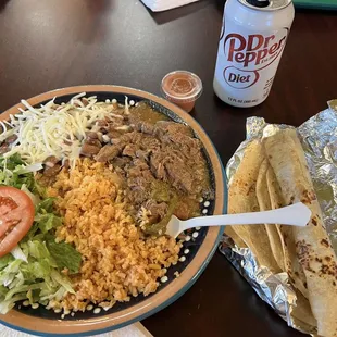 Chili verde, rice salad, cheese on fresh beans. Tortillas, soda and salsa