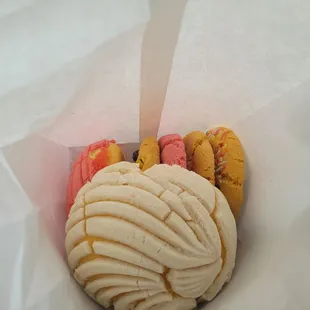 a variety of pastries in a paper bag