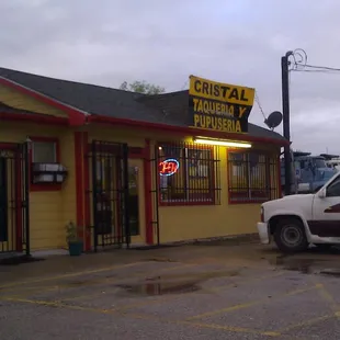 a truck parked in front of a restaurant