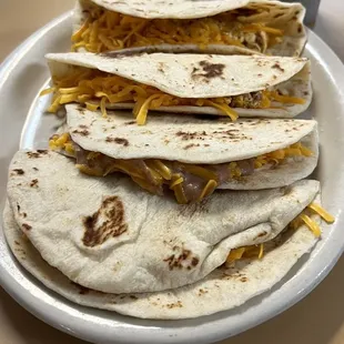 a stack of tacos on a plate