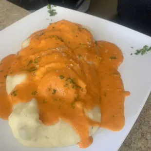 Ravioli sampler over potatoes