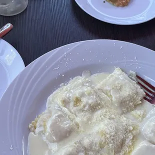 Alfredo cheese ravioli &amp; spinach ravioli in background