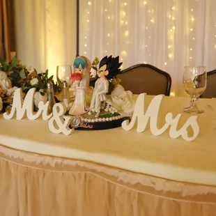 Head table for the bride &amp; groom with gold uplighting by Brighten Up Event Lighting www.brightenuplighting.com