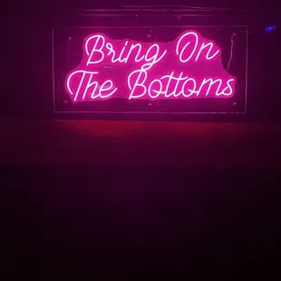 a neon sign saying bring on the buttons