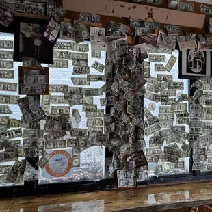 a bar with a lot of money hanging from the ceiling