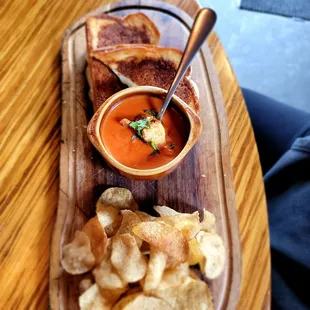 Gooey grilled cheese sandwich with creamy tomato soup. Also delicious and she couldn&apos;t stop eating the crisps!