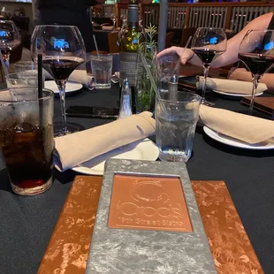 a place setting with a menu on a table