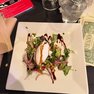 a plate of salad and a glass of water