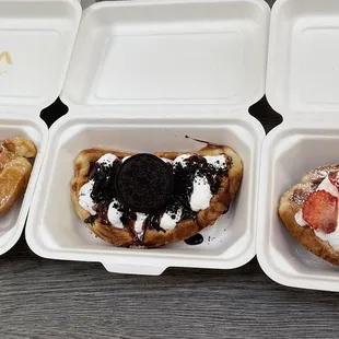 a variety of pastries in a styrofoam container