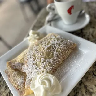a plate of food and a cup of coffee