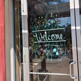 a welcome sign in a window