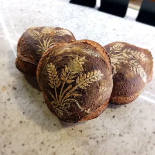 three baked breads on a table