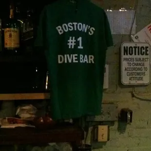 The shirt that hangs behind the bar.