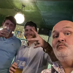 three men drinking beer