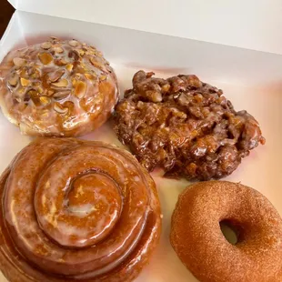 Donut filled with almond paste &amp; topped with almond slivers, Apple fritter, cinnamon roll, &amp; cinnamon sugar donut