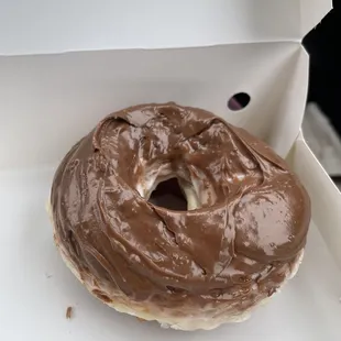 a chocolate frosted donut in a box
