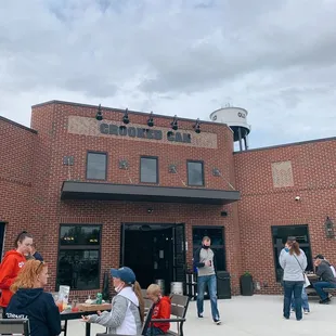 people sitting at tables outside