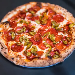 Pep n' step pizza - Smoked mozzarella, house made red sauce, beef pepperoni, cupping pepperoni, jalapenos, red pepper flakes, hot honey